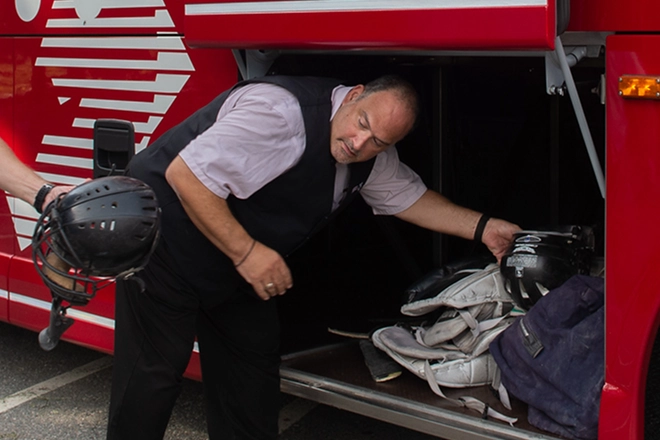 DATTCO Employee organizing athlete stuff